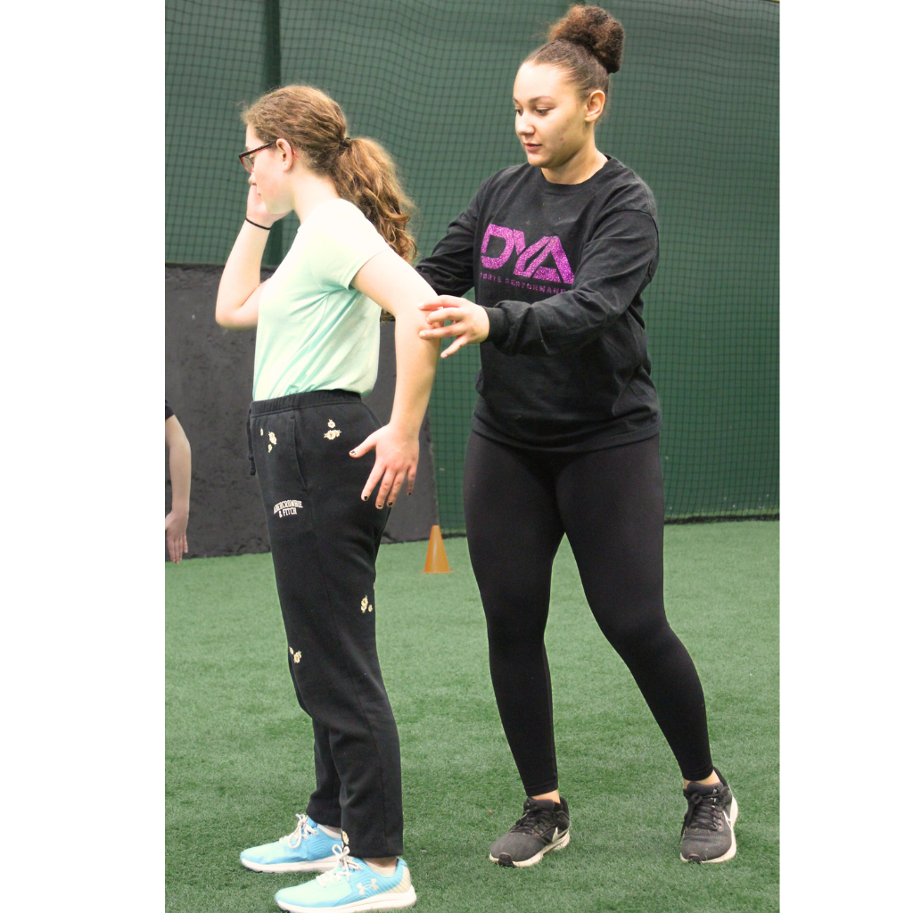 Woman helping young athlete